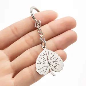 Stainless steel leaf pendant keychain detail shot, showing delicate metal texture and fine line carving.