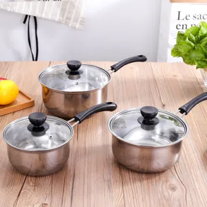 Stainless steel saucepan set with glass lids and handles, durable cookware for home kitchen.