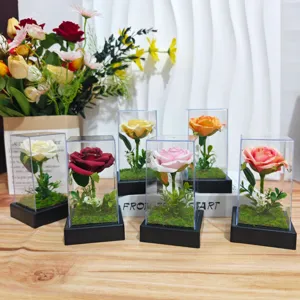 Detailed view of colorful artificial rose flowers in transparent display boxes for gift and decor.