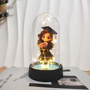 LED graduation night light detail shot, acrylic cover with cute cartoon figure and warm fairy lights.