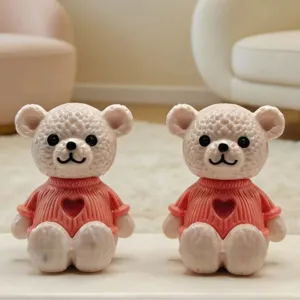 Detalle de figuritas de ositos en miniatura, jersey rosa con corazón, decoración de escritorio.