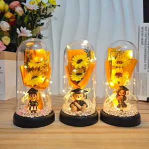 Graduation gift acrylic glass dome sunflower night light with cute student bear and LED string lights.