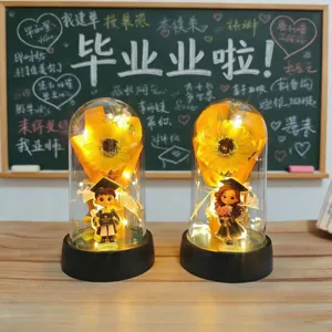 Graduation sunflower preserved flower night light with student doll figures for commemorative gifts.