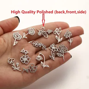 Detail view of birth flower stainless steel pendants, perfect for DIY jewelry making.