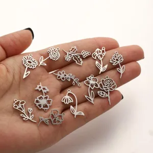 Stainless steel birth flower pendants set, DIY charm jewelry detail view showing various floral shapes.