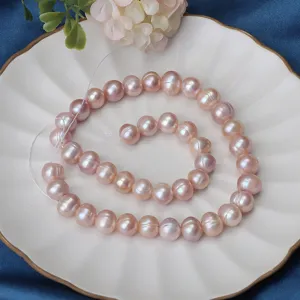 Filo di perle d'acqua dolce rosa naturali, perle rotonde da 9-10mm presentate su piatto.