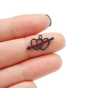 Close-up detail of black stainless steel double heart arrow pendant, perfect for DIY jewelry.