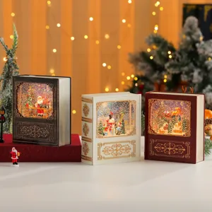 Christmas book snow globe ornament detail, vintage style festive desktop decoration light.