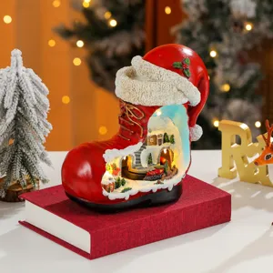 Christmas boot resin music box detail view showing miniature snowy village scene and warm lights.
