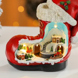Detailed view of resin Christmas boot micro landscape ornament with glowing lights inside.