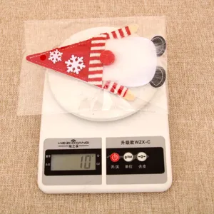 Detail view of Christmas gnome felt cutlery holder decoration, showing fine texture and weight.
