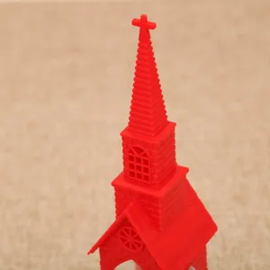 Red church shaped night light decor, miniature Christmas house spire model for holiday display.