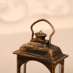 Vintage style decorative Christmas wind lantern detail view, elegant retro black gold finish.