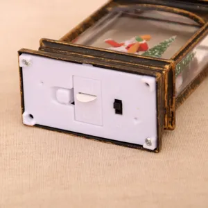 Close-up of the battery compartment and switch detail of a Christmas water lantern ornament.
