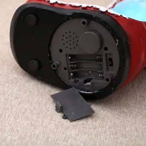 Bottom detail view showing the battery compartment and switch of the Christmas music box.
