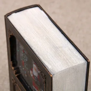 Detailed view of the Christmas book shaped water snow globe music box desktop ornament gift.