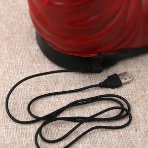 USB power cable and connector detail close-up view of resin Christmas boot music box base.