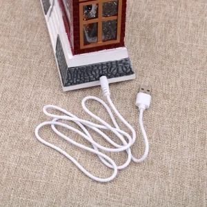 Detail shot of Christmas decorative lamp USB power cable connection port and white wire.