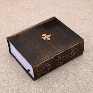 Retro book shaped music box detail, vintage brown decorative desktop ornament with emblem.