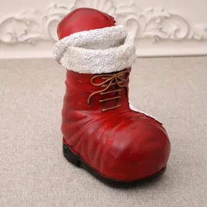 Christmas resin boot music box decoration, festive Santa boot ornament for holiday home table.