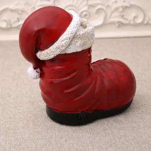 Detailed view of Christmas resin boot music box, festive glowing tabletop decoration gift.