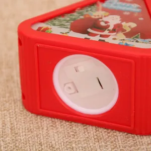 Christmas vintage night light detail view with battery compartment and Santa print decor.