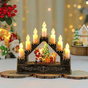 Detalle de vela bola de nieve arco navideño, decoración de mesa LED festiva y cálida.