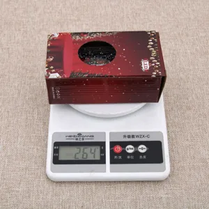 Détail de la boîte d'emballage veilleuse boule à neige de Noël affichant 264g sur balance