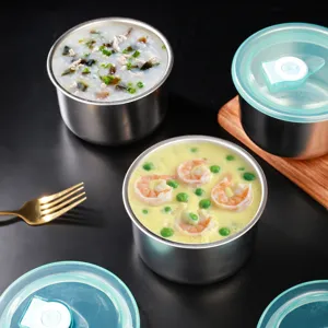 Stainless steel baby food bowl detail view, showing fresh egg custard and congee inside.