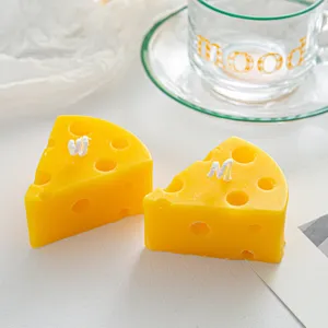 Close up detail of cute cheese shaped scented candle, aesthetic home decor and photography prop.