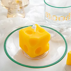 Cute cheese scented candle detail, creative yellow wax cube decoration for home desktop decor.
