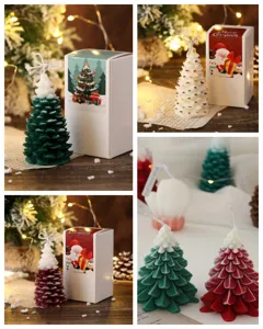 Close up view of exquisite Christmas tree scented candles with gift box and festive holiday decor.