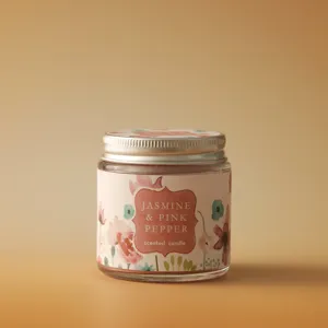 Jasmine and pink pepper scented candle in a clear glass jar with metal lid, detail view.