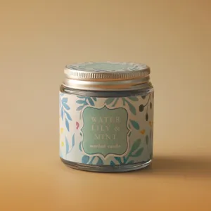 Detailed view of a scented candle in a glass jar with a mint and water lily label.