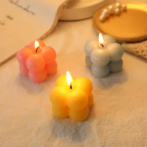 A detailed view of creative pastel bubble scented candles burning, perfect for decor.