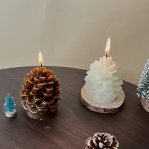 Detailed view of Christmas pinecone scented candles made of soy wax, burning wick and decor.