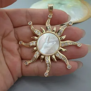 Gold-plated vintage sun pendant featuring a white mother of pearl center and sparkling cubic zirconia.