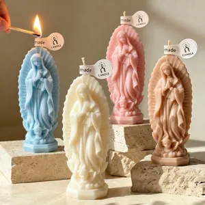Detailed shot of scented prayer figure candles on stone props, warm home decor gift option.