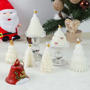 Detailed view of white Christmas tree scented candles, perfect holiday home decor and gifts.