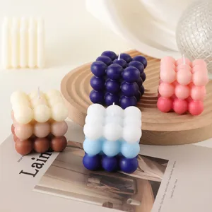 Detailed view of aesthetic gradient bubble cube soy wax scented candles, creative home decor prop.