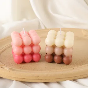 Close-up of gradient bubble scented candles on a round tray for cozy home decor aesthetics.