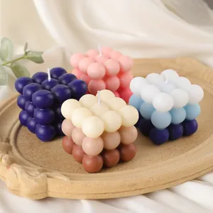 Detailed close-up shot of colorful gradient bubble scented cube candles neatly arranged on a retro tray.