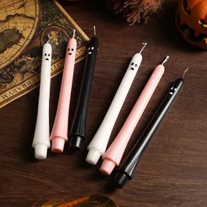 Detail shot of cute ghost tapered candles for Halloween party decor and festive atmosphere.