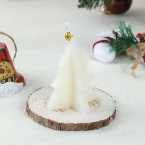 White Christmas tree scented candle with bell detail, perfect holiday decorative wax piece.