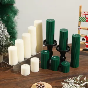 Detailed shot of ribbed pillar soy wax scented candles in festive holiday home decor.