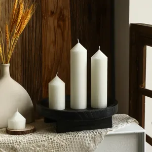 Nordic minimalist white striped pointed pillar candle scene detail showing aesthetic home decor.