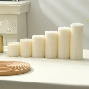 Detailed view of white Nordic ribbed pillar scented candles, elegant home decor and wedding gift.