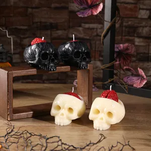 Close-up detail of gothic skull scented candles with red brain design for Halloween party decor.