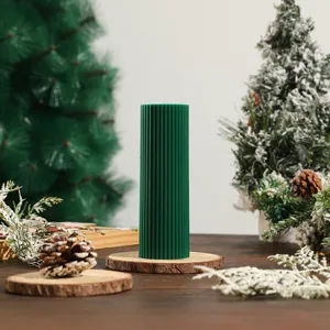 Christmas striped scented candle detail, dark green soy wax pillar candle with festive home decor.