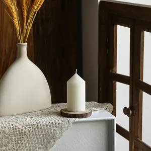 White striped pillar scented candle, pointy top geometric design for Nordic home decor.